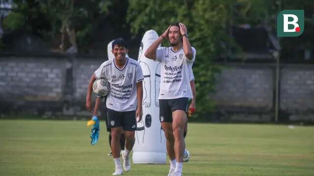 Bek tengah baru Bali United, Ryuji Utomo, saat bersenda gurau dengan gelandang Sandi Sute usai sesi latihan tertutup di Lapangan Gelora Trisakti Legian pada Rabu (11/1/2023). (Bola.com/Maheswara Putra)