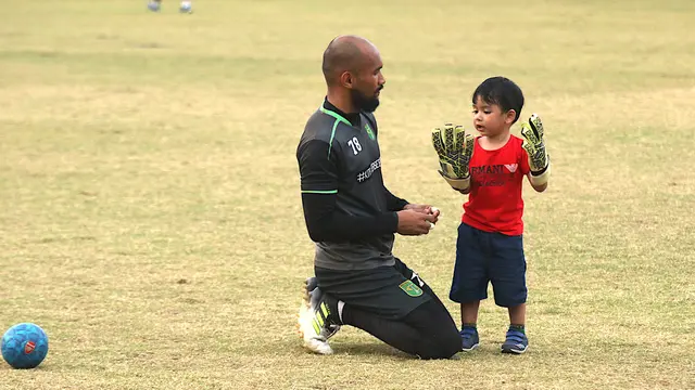 Kiper Persebaya, Alfonsius Kelvan dan sang putra, Muhammad Sultan Arzachel di Lapangan Polda Jatim, Surabaya, Selasa sore (7/8/2018). (Bola.com/Aditya Wany)